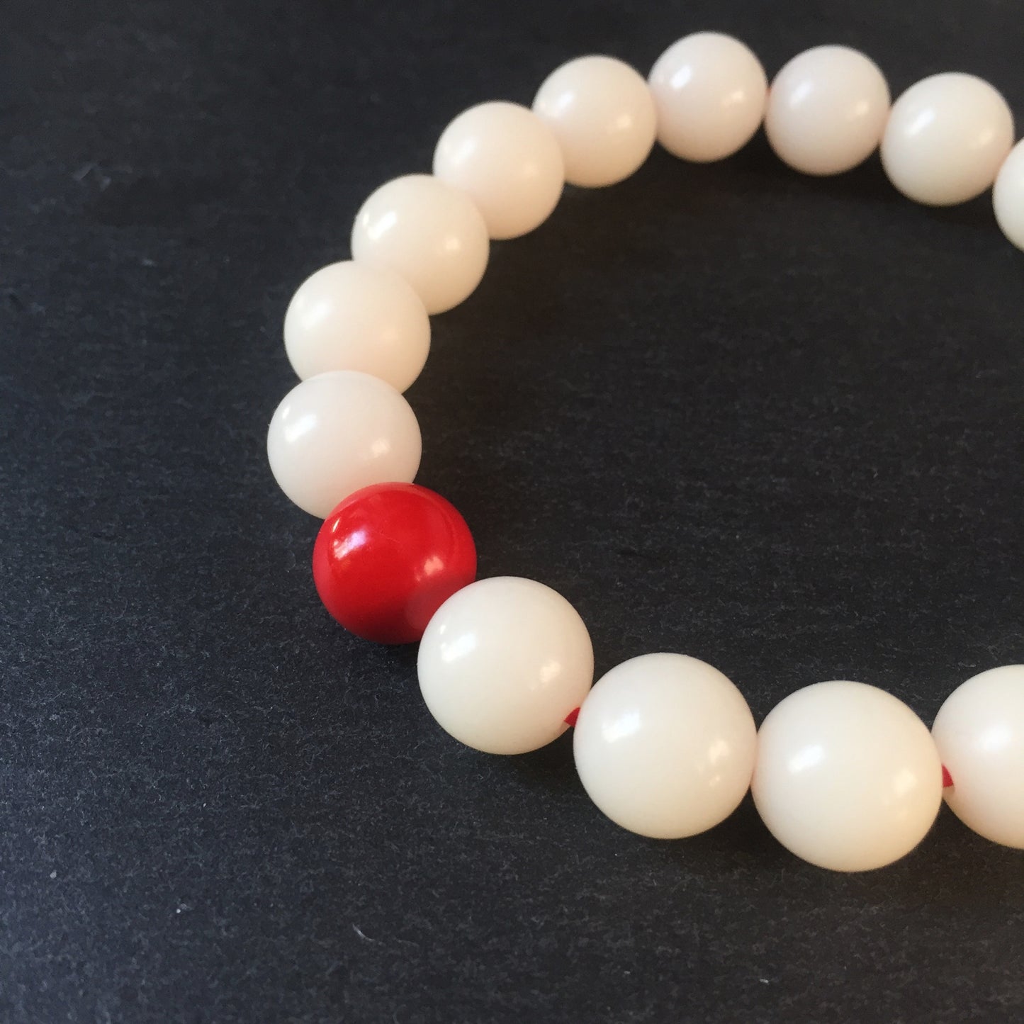 Creamy White Bodhi Seed Mala Bracelet with Red Cinnabar Bead.